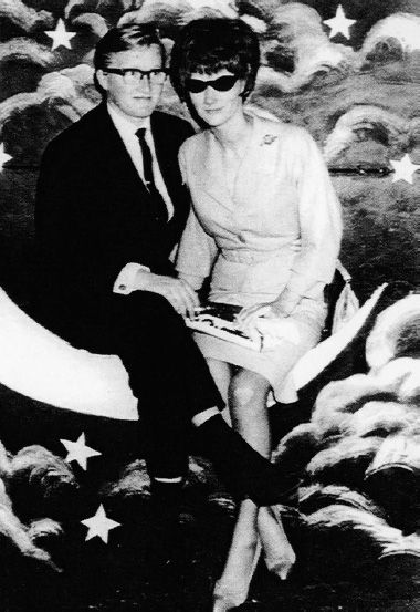 Photo of Hillier (in suit and tie) sitting with her girlfriend on famous ‘Moon Seat’ in the Photo Studio at Luna Park. Unknown photographer. [Photograph]